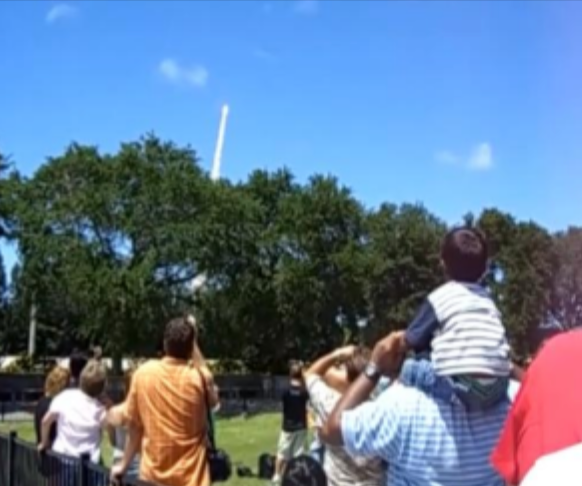 Jacob as a child watching a Space Shuttle launch at Kennedy Space Center